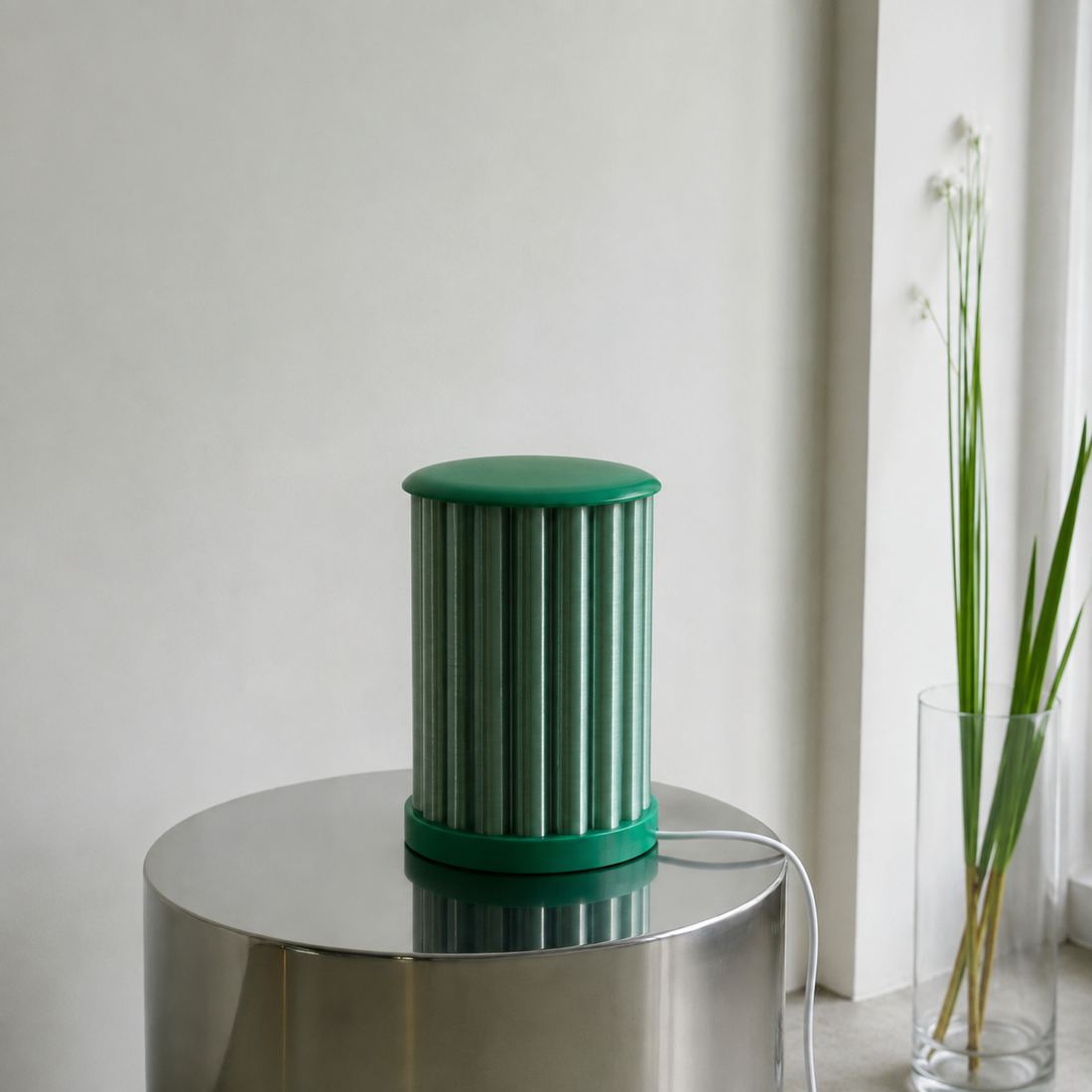 Lampe cannelée verte sur un guéridon en inox